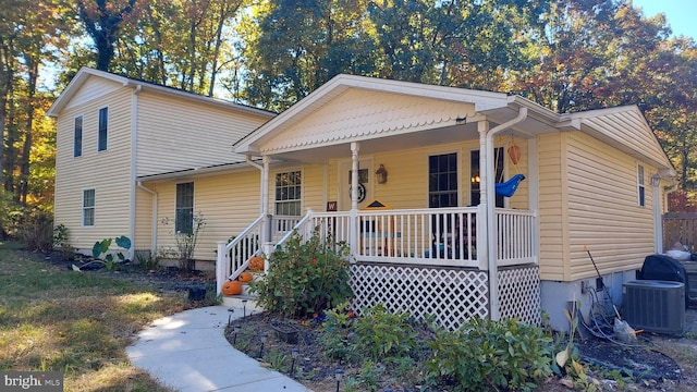 view of front of home featuring a porch and cooling unit