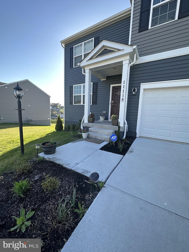 view of front of home with a garage and a front yard