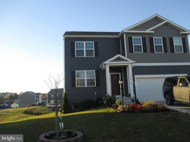 view of front of property with a front yard and a garage