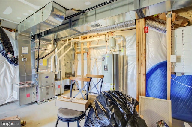 basement featuring heating unit and water heater