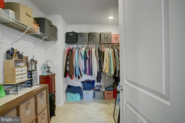 walk in closet featuring carpet flooring