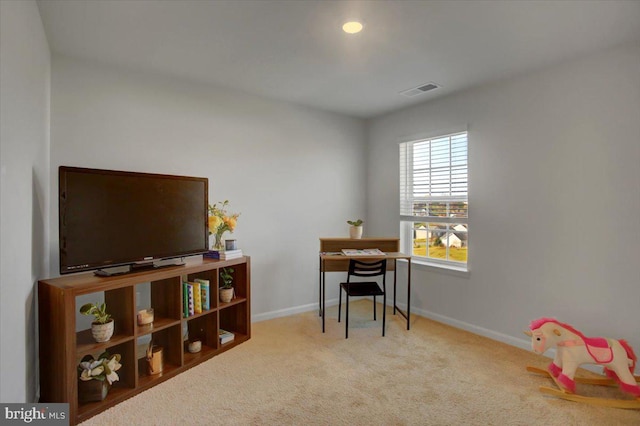 recreation room with light colored carpet