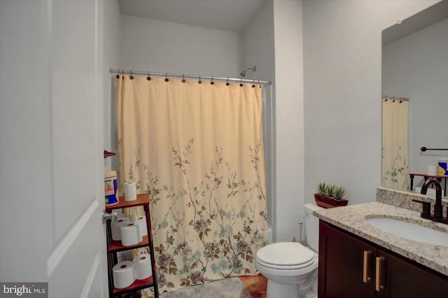 bathroom featuring vanity and toilet