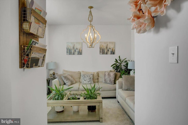 carpeted living room with a notable chandelier