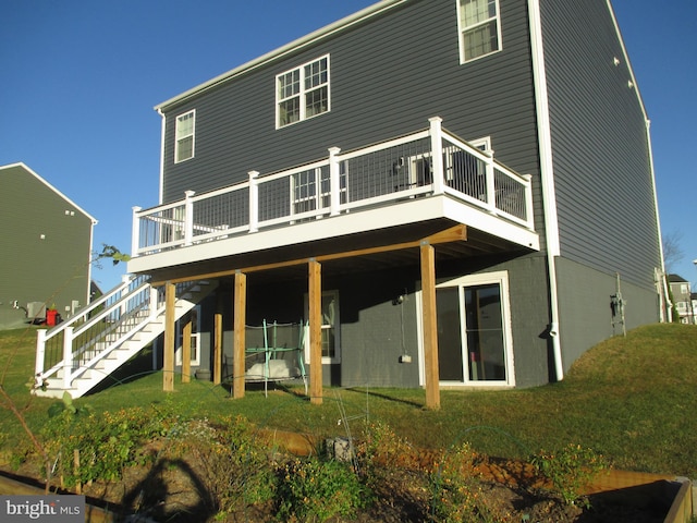 back of house with a deck