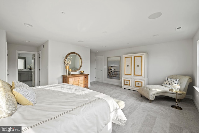 carpeted bedroom featuring ensuite bath