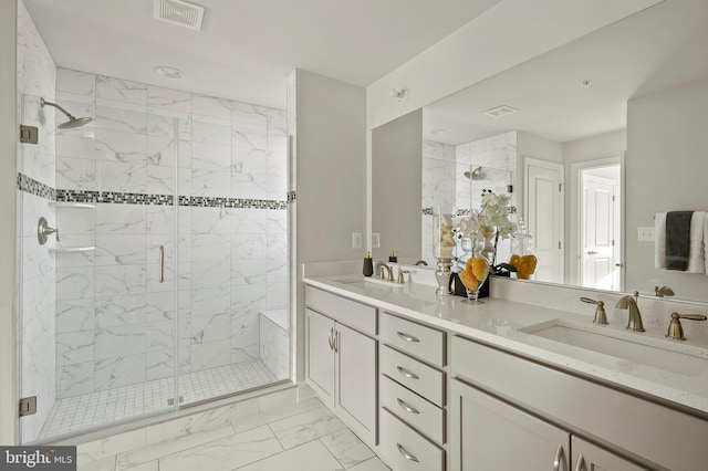 bathroom with vanity and a shower with door