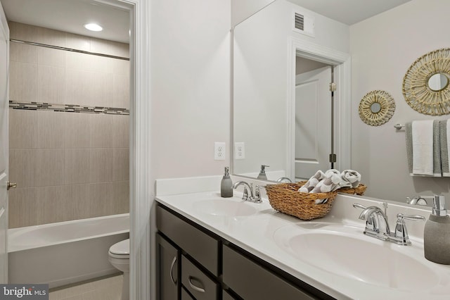 full bathroom with tiled shower / bath, vanity, toilet, and tile patterned flooring