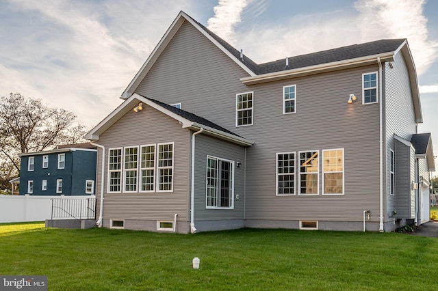 rear view of house with a yard