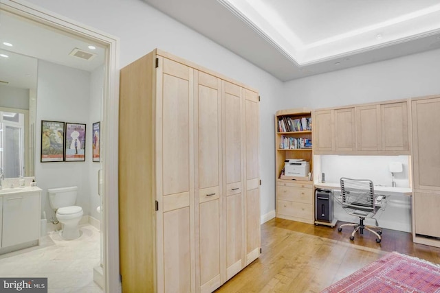 office area featuring built in desk and light hardwood / wood-style floors