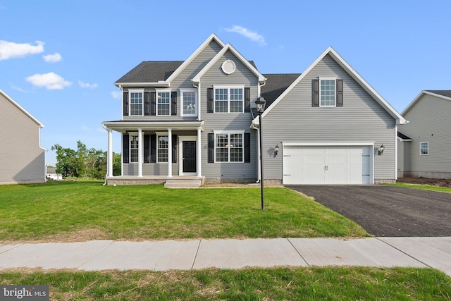 view of front of house with a front yard and a garage