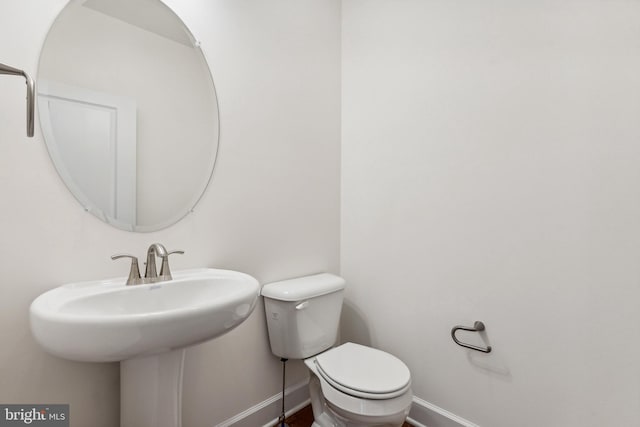 bathroom featuring toilet and sink