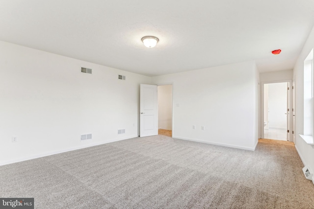 unfurnished room with light carpet