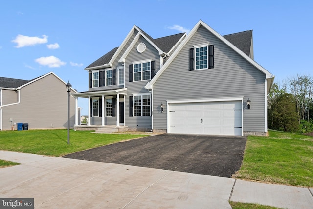 view of front of property featuring a front yard and a garage