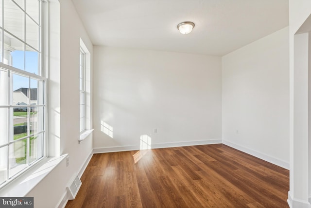 empty room featuring dark wood-type flooring