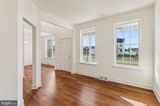 empty room featuring dark hardwood / wood-style flooring