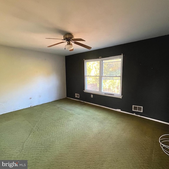 unfurnished room with carpet and ceiling fan