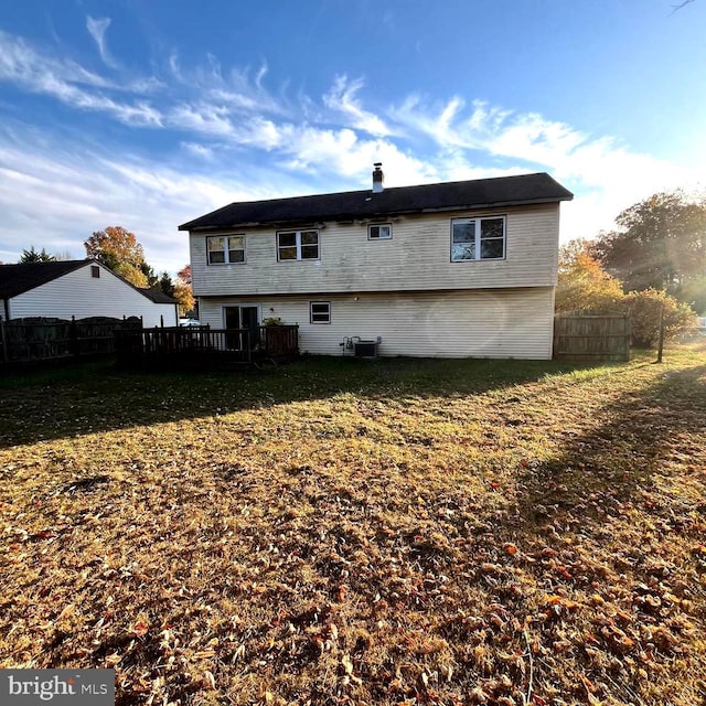 rear view of property featuring a yard