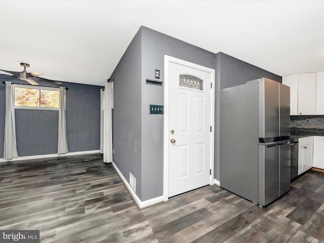 kitchen with white cabinetry, dark hardwood / wood-style floors, ceiling fan, and stainless steel fridge