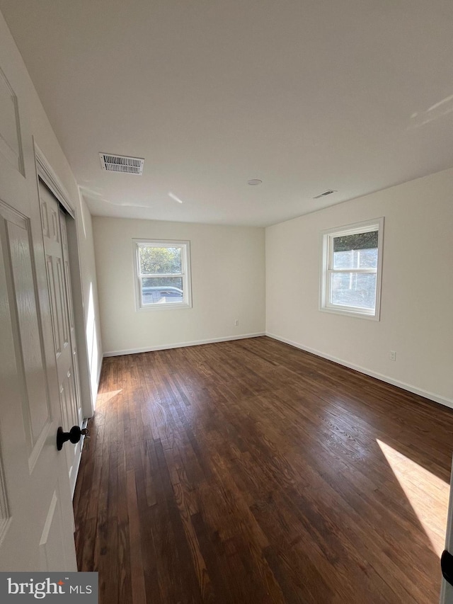 spare room featuring dark hardwood / wood-style floors