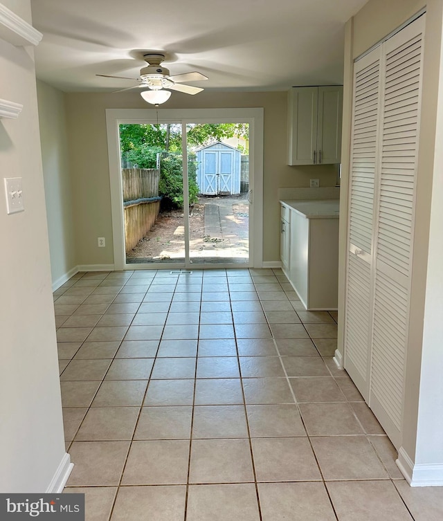 interior space with ceiling fan and light tile patterned flooring