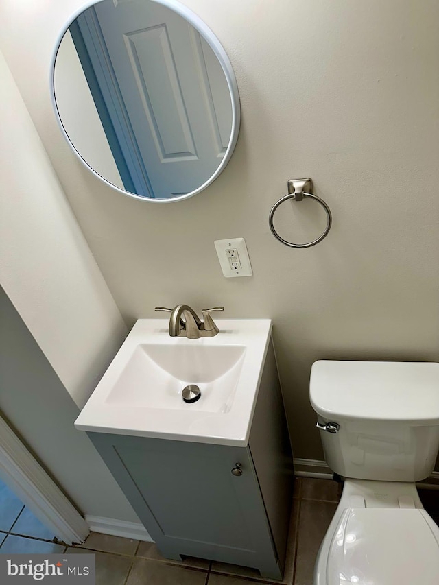 bathroom featuring vanity, toilet, and tile patterned flooring