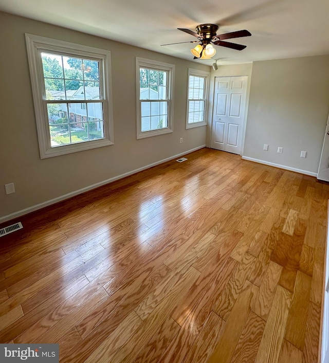 empty room featuring ceiling fan and light hardwood / wood-style flooring