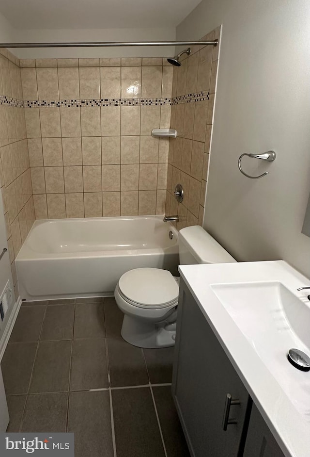 full bathroom with vanity, toilet, tile patterned floors, and tiled shower / bath