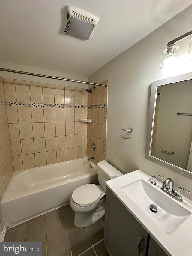 full bathroom featuring vanity, toilet, tile patterned flooring, and tiled shower / bath