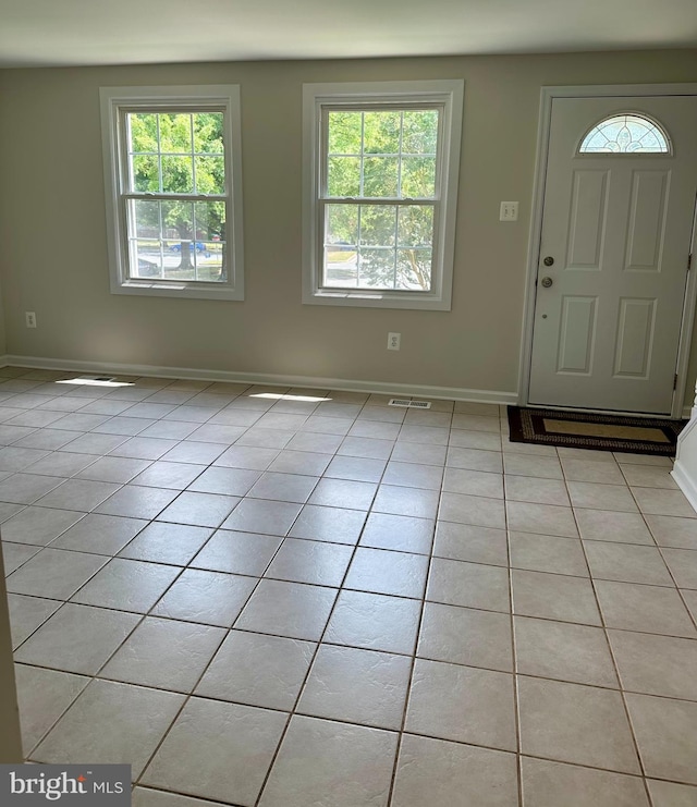 tiled entrance foyer featuring plenty of natural light