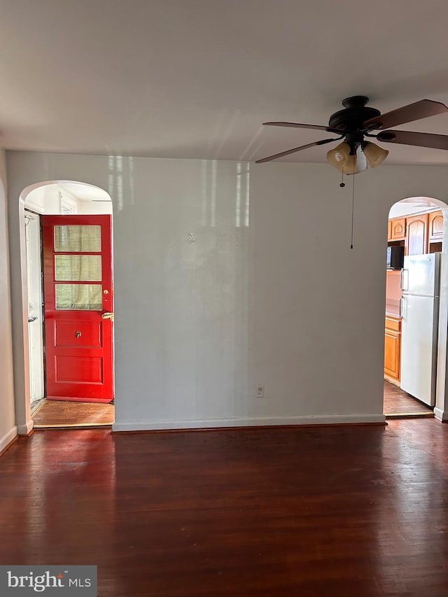 spare room with ceiling fan and dark hardwood / wood-style flooring