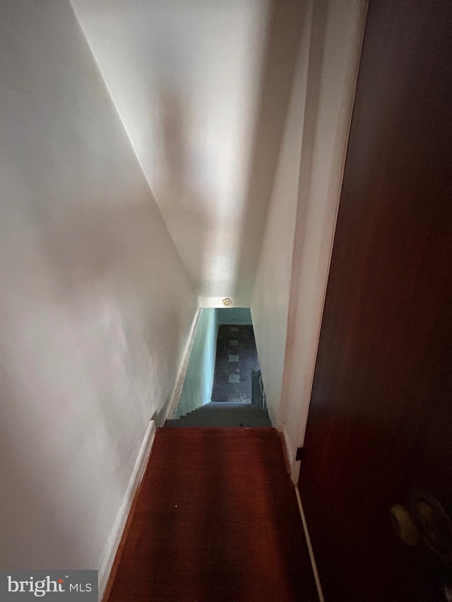 stairway featuring lofted ceiling