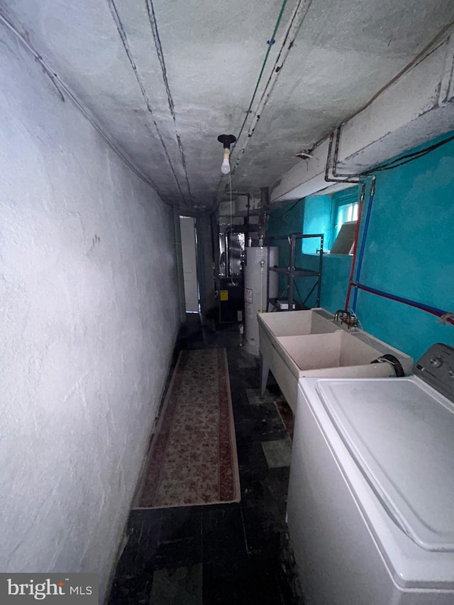 basement featuring gas water heater, heating unit, and washer / clothes dryer