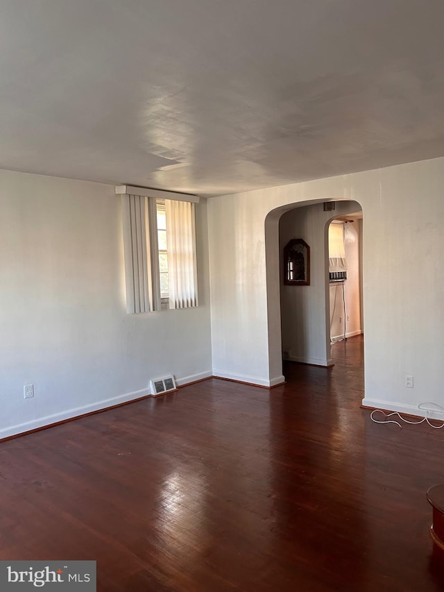 empty room with dark wood-type flooring