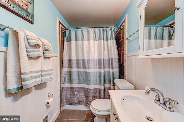 bathroom featuring toilet, vanity, and tile patterned floors