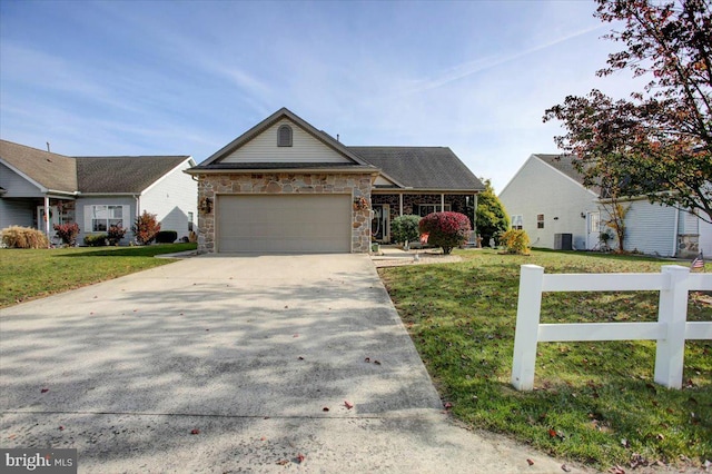 view of front facade with a front lawn, central AC, and a garage