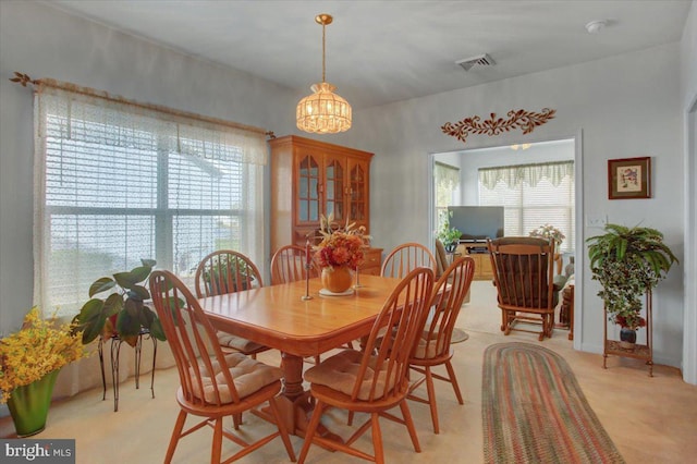 dining space with an inviting chandelier