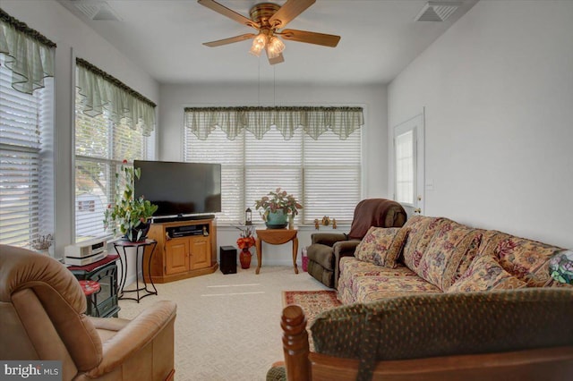 carpeted living room with plenty of natural light and ceiling fan