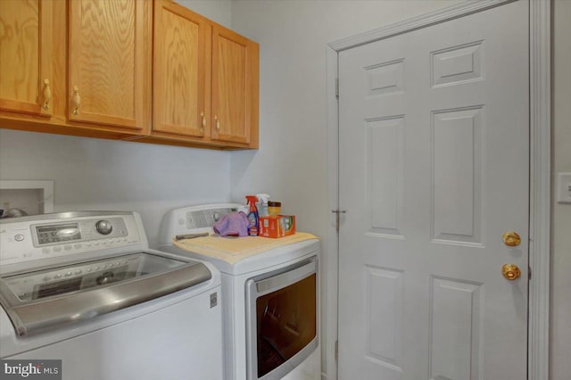 laundry room featuring cabinets and separate washer and dryer