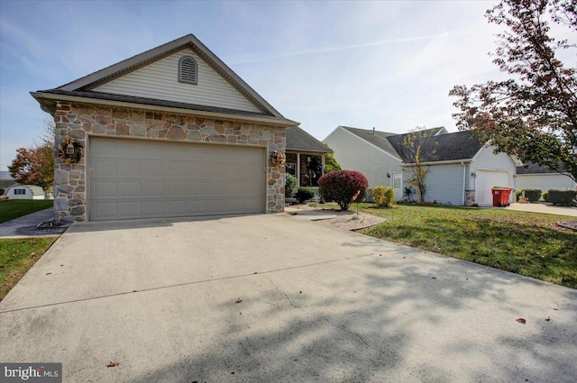 view of front of home with a front lawn and a garage