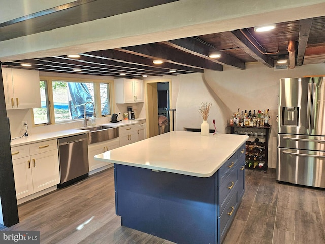 kitchen featuring sink, dark hardwood / wood-style floors, white cabinets, wood ceiling, and appliances with stainless steel finishes