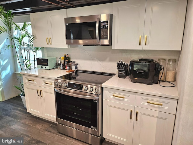 kitchen featuring white cabinets, dark wood-type flooring, and appliances with stainless steel finishes