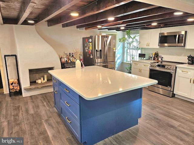 kitchen featuring wood-type flooring, white cabinetry, and appliances with stainless steel finishes