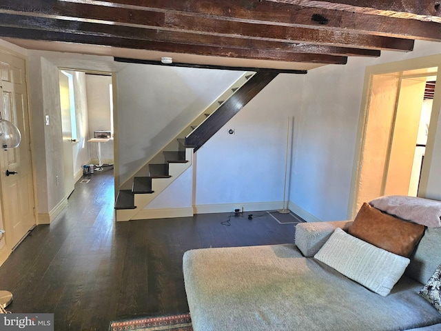 interior space with beamed ceiling and dark hardwood / wood-style floors