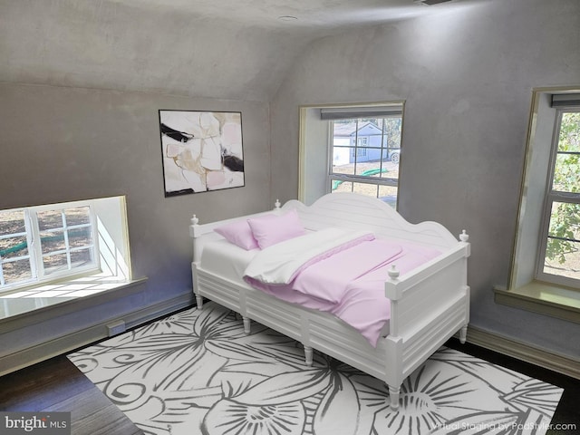 bedroom featuring hardwood / wood-style floors and vaulted ceiling