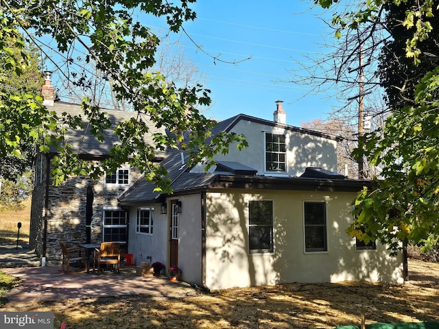 back of house with a patio