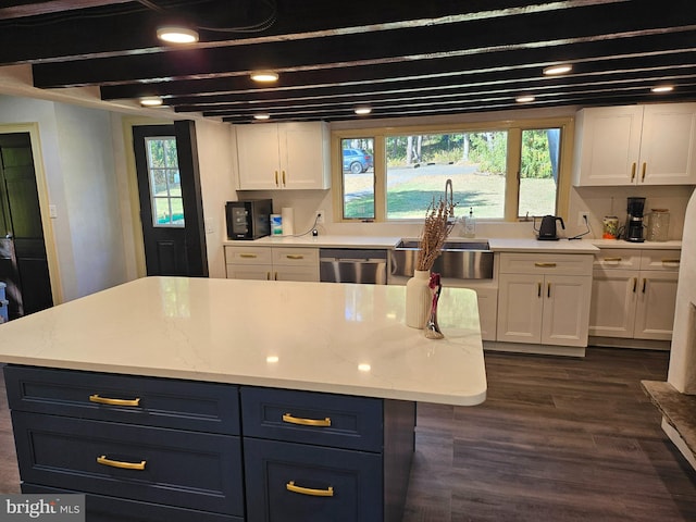 kitchen with dishwasher, dark hardwood / wood-style flooring, white cabinetry, and sink