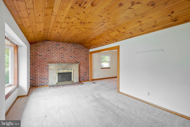 unfurnished living room with light carpet, a fireplace, wood ceiling, and vaulted ceiling