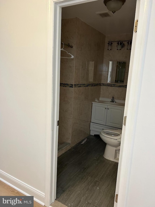 3234 Fanshawe St, Philadelphia, PA 19149 - bathroom with vanity, tiled shower, hardwood / wood-style flooring, and toilet
