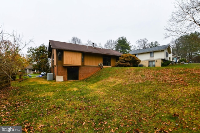 view of home's exterior with a lawn and central air condition unit